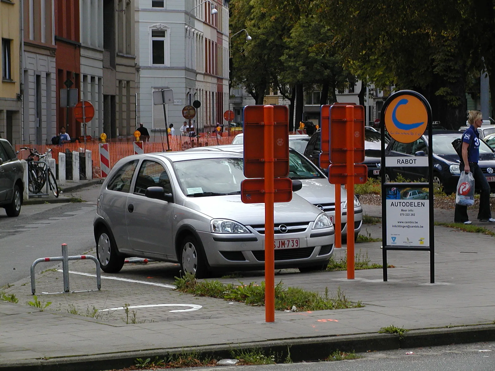 Rue urbaine avec véhicule d'autopartage stationné entre particuliers